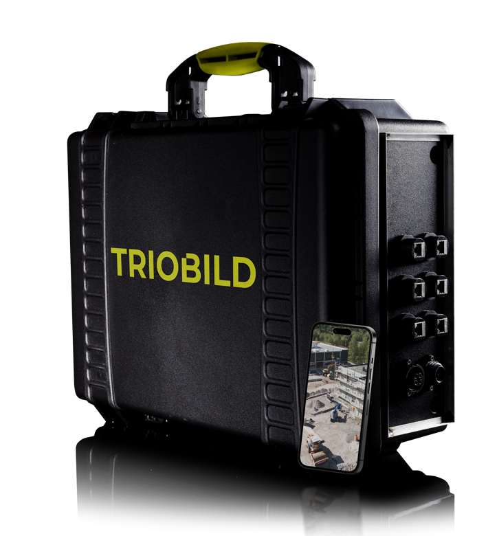 Die TRIOBOX: ein robuster schwarzer Koffer mit TRIOBILD-Schriftzug, davor ein Smartphone mit Baustellen-Livebild.